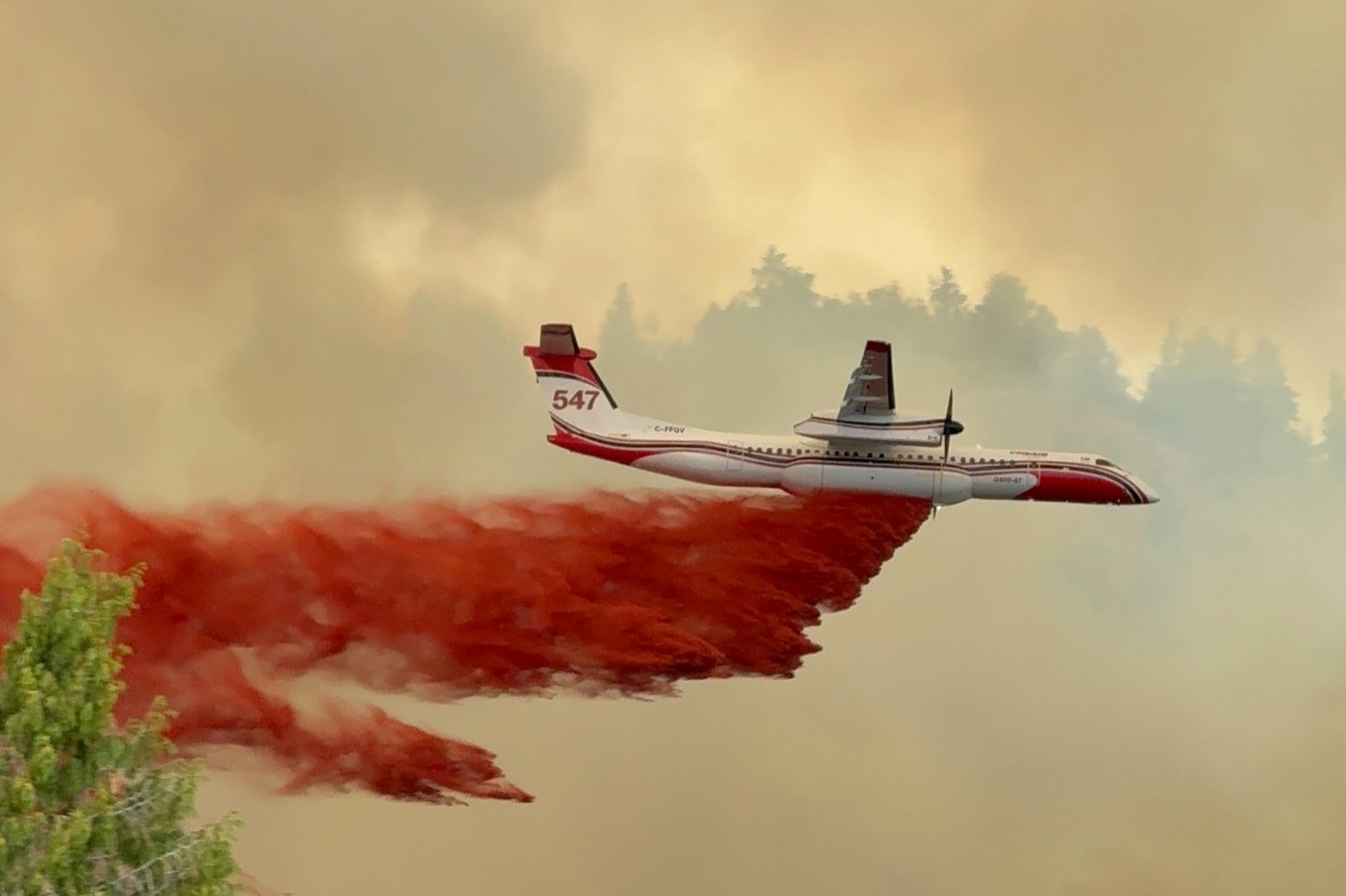 Retardant drop over a forest ridge